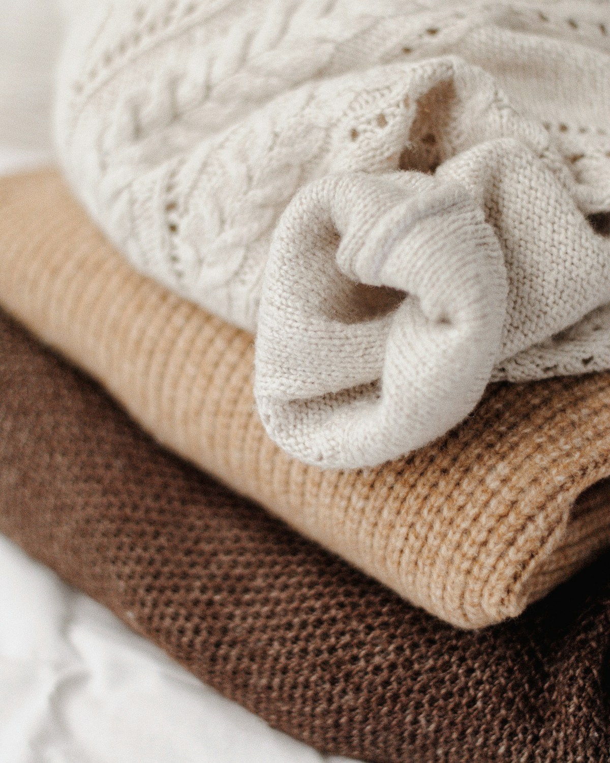 Assorted knitted textiles in muted autumn colours