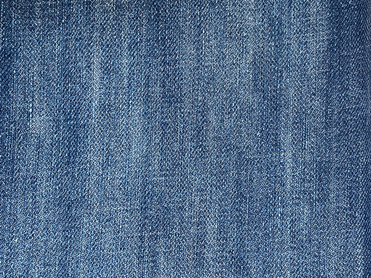 Close-up of worn blue denim fabric texture