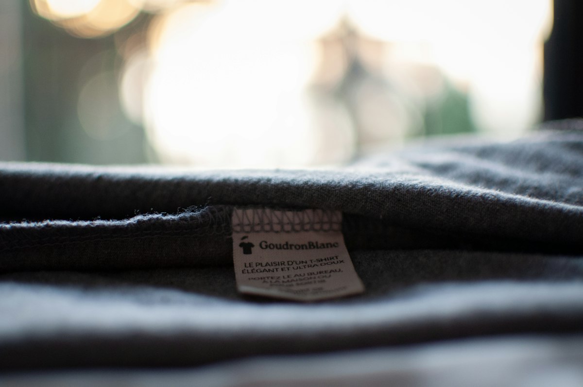 A close-up of a clothing label sewn into a shirt