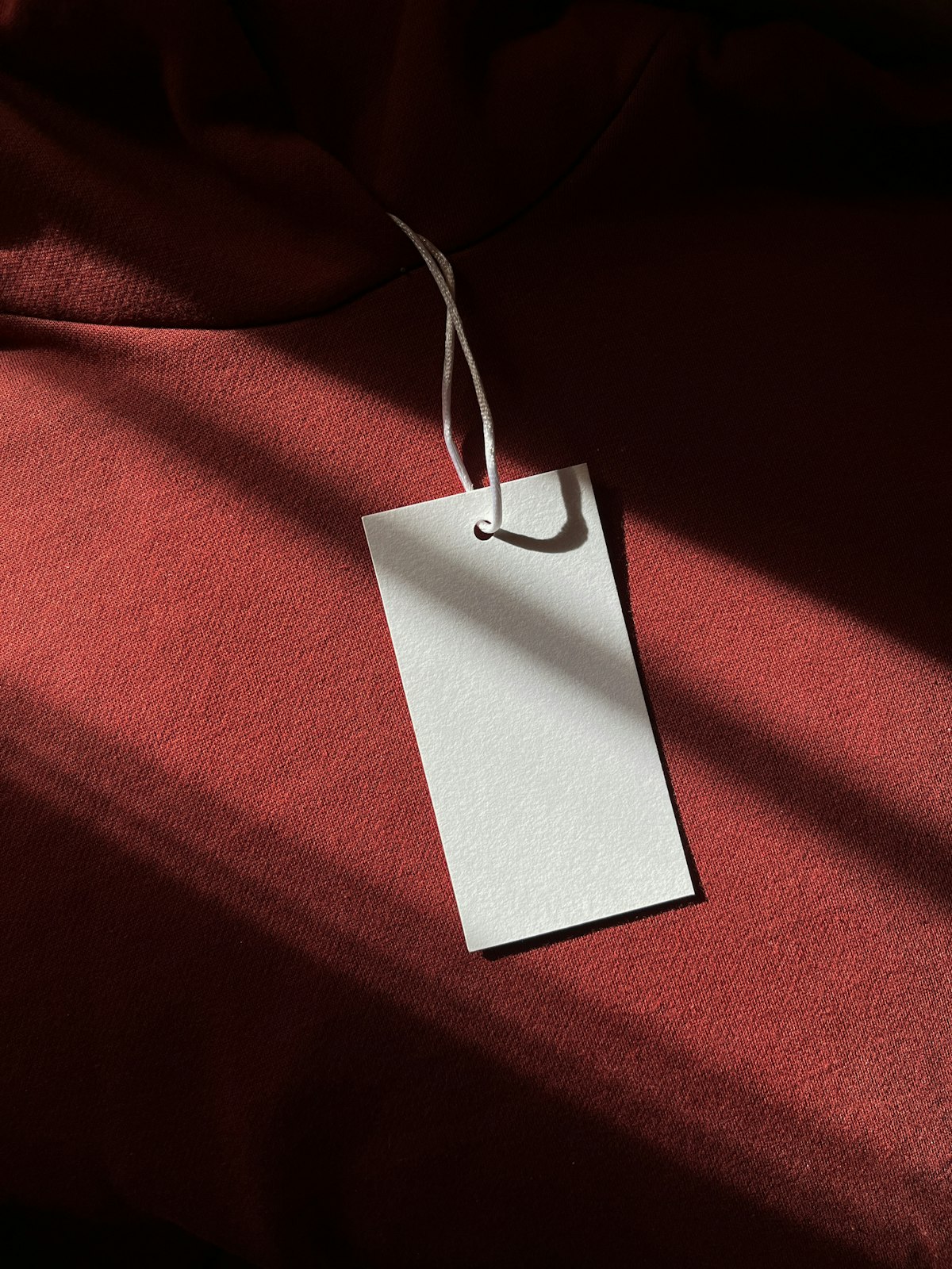 A white hangtag attached to a red garment
