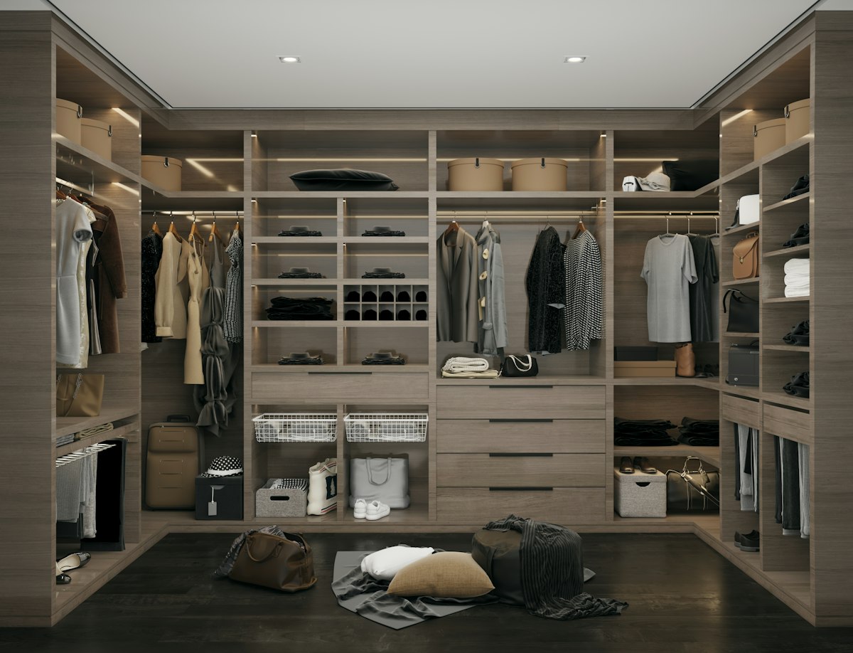 A walk-in wardrobe full of clothes, shoes and bags