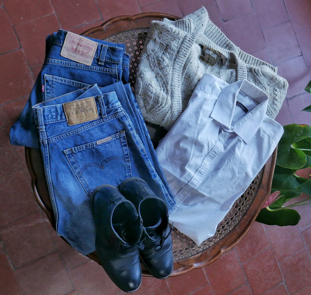 A folded bundle of jeans, a knit and a shirt ready to swap