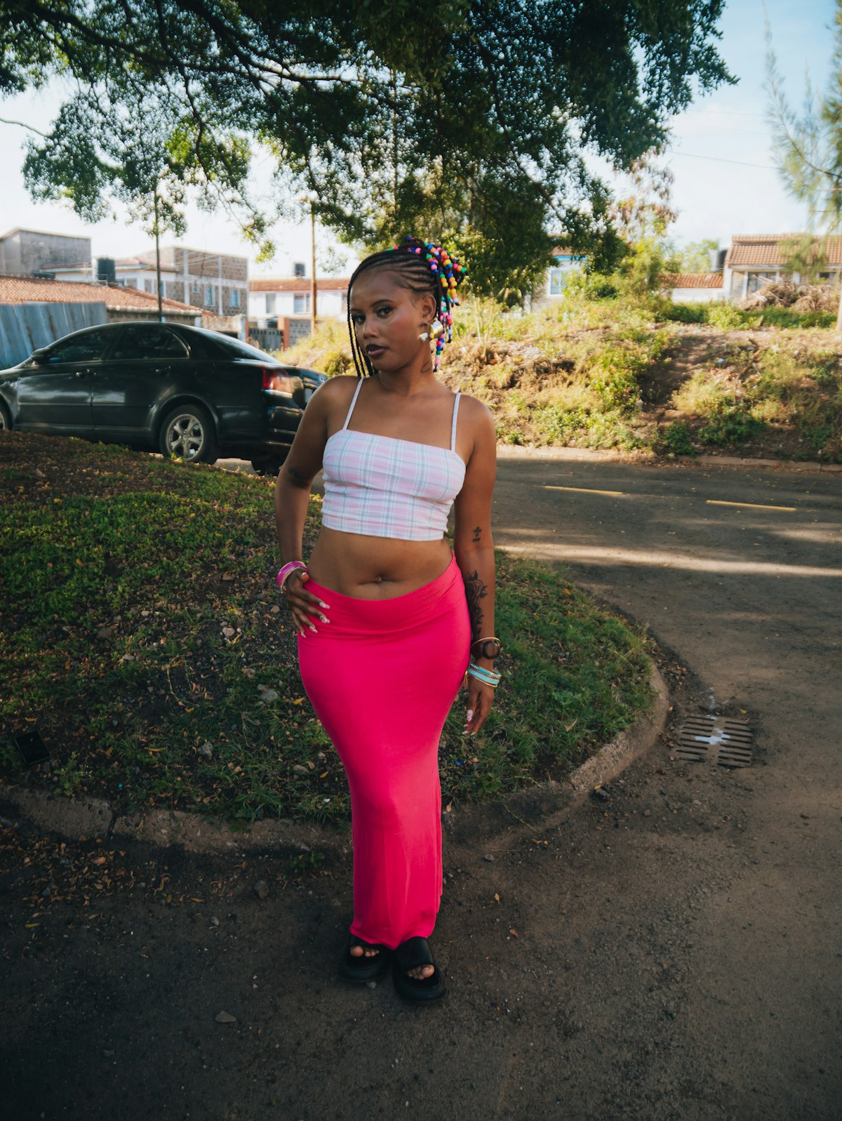 A confident personal-style look — plaid top and bright pink maxi skirt