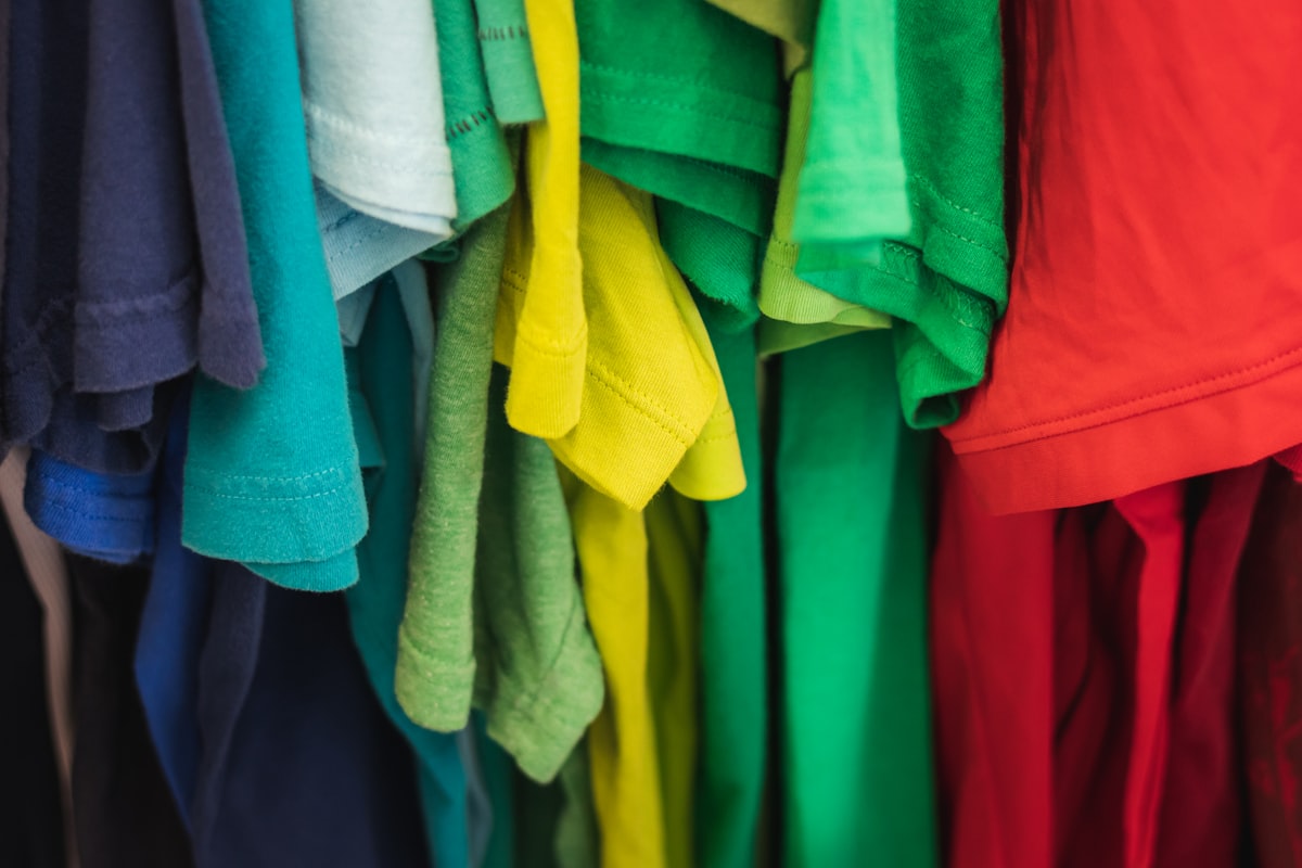 Brightly coloured second-hand clothes on a rail